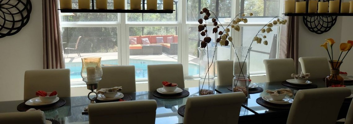Dining table indoors overlooking pool